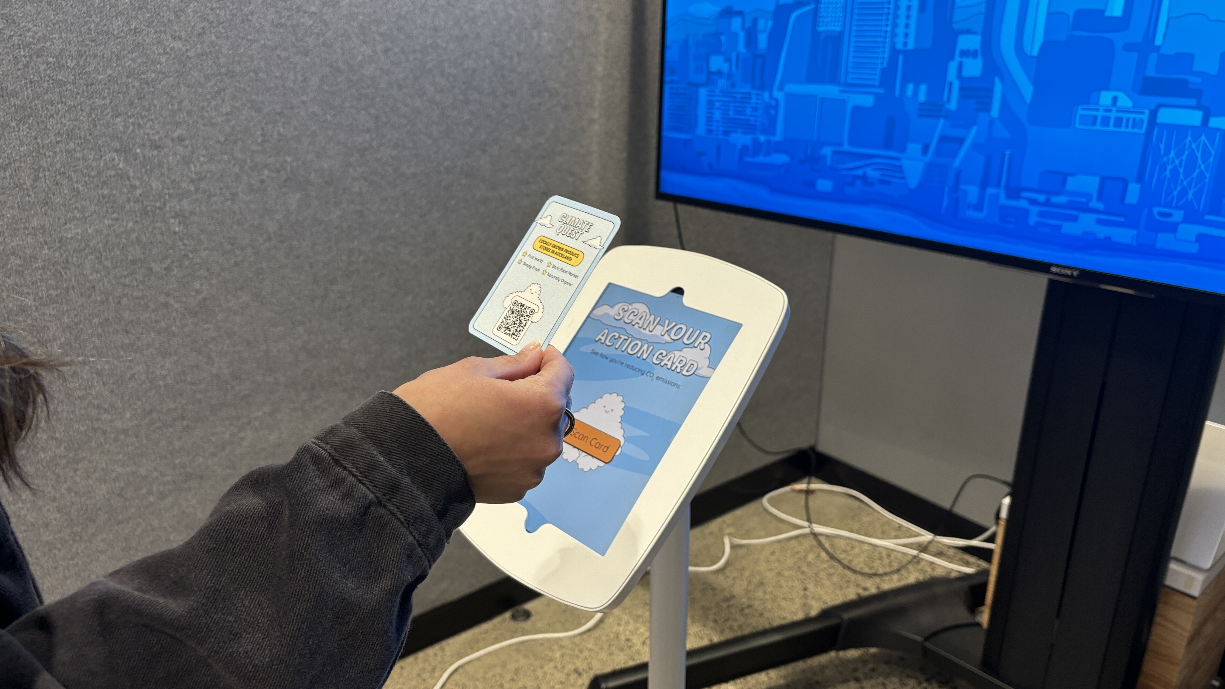 Visitor scanning an action card on the iPad